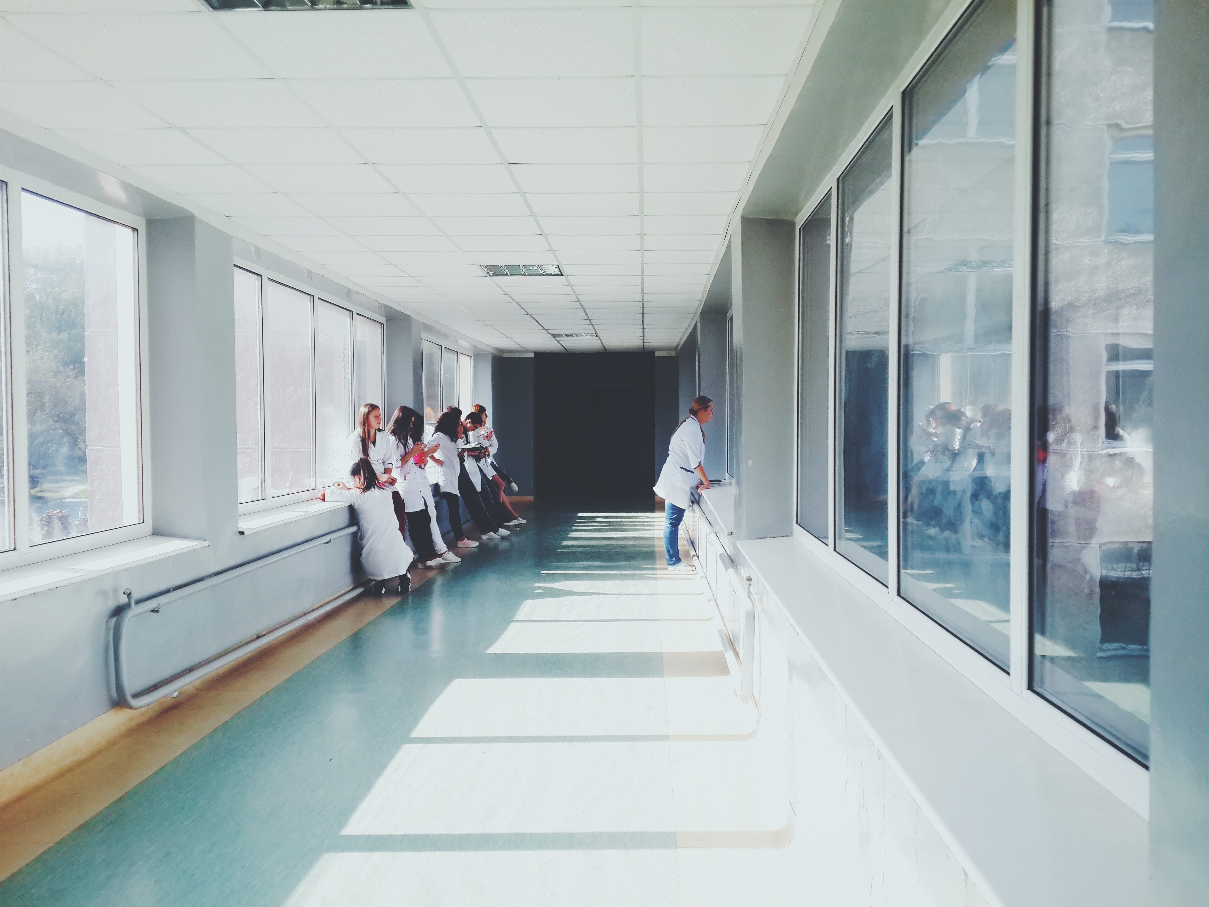 Doctors in hospital hallway with interactive kiosks