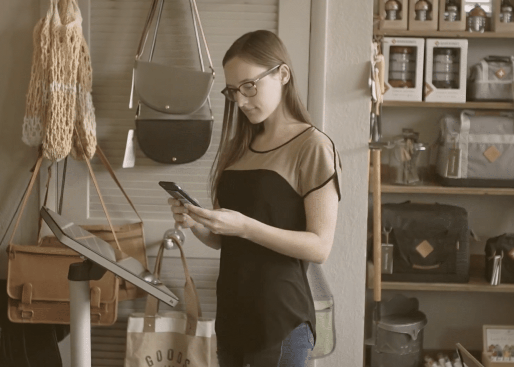 Girl Using Phone in Store